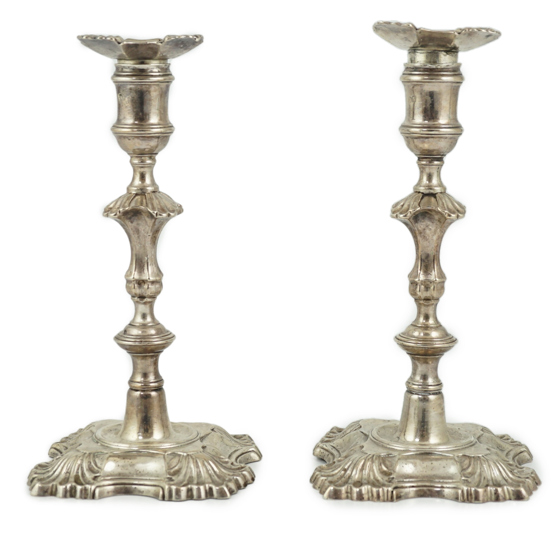 A pair of George II cast silver candlesticks by William Gould
